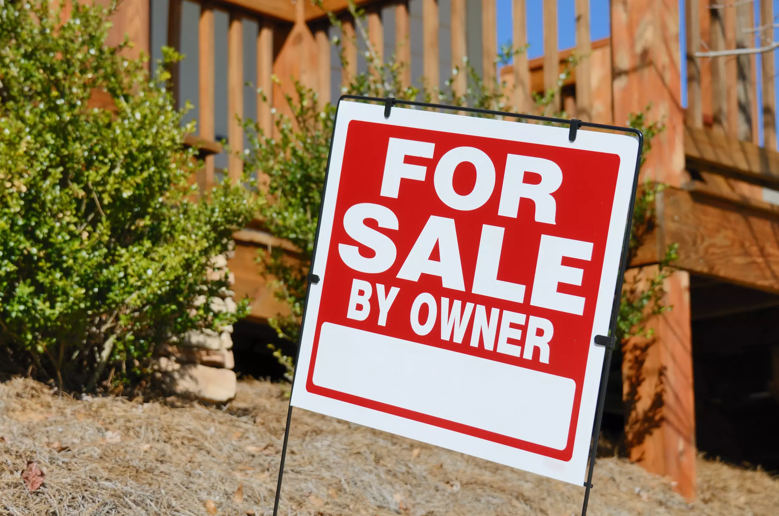 For Sale By Owner sign in front of a house